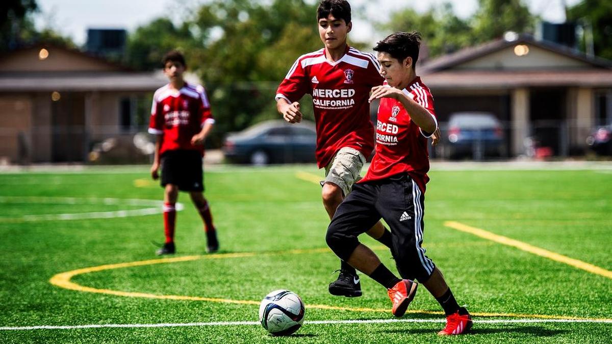 
Juan Valenzuela, 13, of Atwater, right, protects the ball from Humberto Manzo, 15, of Merced, who are both in Merced Atlas Soccer Academy, at McNamara Park in Merced  in June. 
