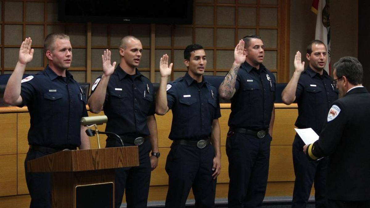 New firefighters for Merced City Fire are sworn in Friday, May 20, 2016, in City Hall by Chief Shawn Henry. From left, Jack Jones, Thomas Beard, Aaron Vasquez, Paul Skifter and Samuel Rametta pledge to serve the city.