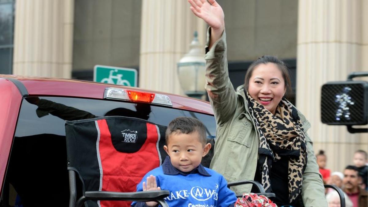 Parade grand marshal Raidyn Saechao, 4, and his mother, Joanmae Hernandez, 30, of Merced ride in the Merced Christmas parade on Saturday, Dec. 5, 2015, as part of the entry from the Make-A-Wish Foundation. Scores of floats, cars, horses, bands and motorcycles joined the procession on Main Street.