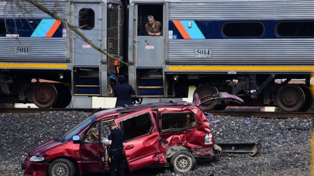 Merced police and Amtrak employees investigate at the U Street crossing where a train collided with a van carrying a woman Monday. The woman was airlifted to a Modesto hospital, according to police.