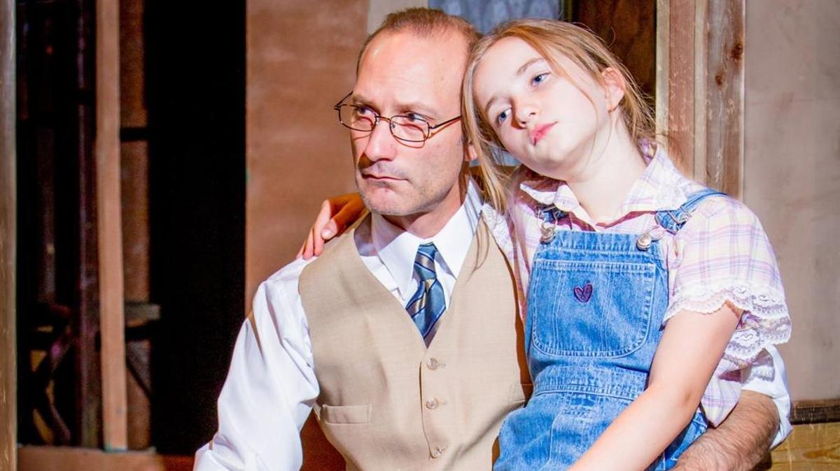 Atticus Finch and Scout, played by Colton Dennis and Jade Seymour, ponder during a recent rehearsal of “To Kill a Mockingbird” at the Merced Theatre. The special collaboration premieres 7:30 p.m. Friday, June 10, at the theater, 301 W. Main St.