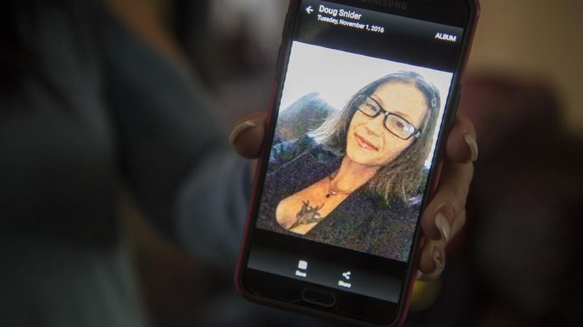 Denise Sawyer, 56, displays a photo of daughter Rene Snider in Merced on Nov. 1. Sawyer’s granddaughters Lyza Martinez, 11, and Drea Martinez, 12, were not returned to their father, Jose Martinez, and stepmother, Tabitha Martinez, after visiting with Snider, their biological mother.
