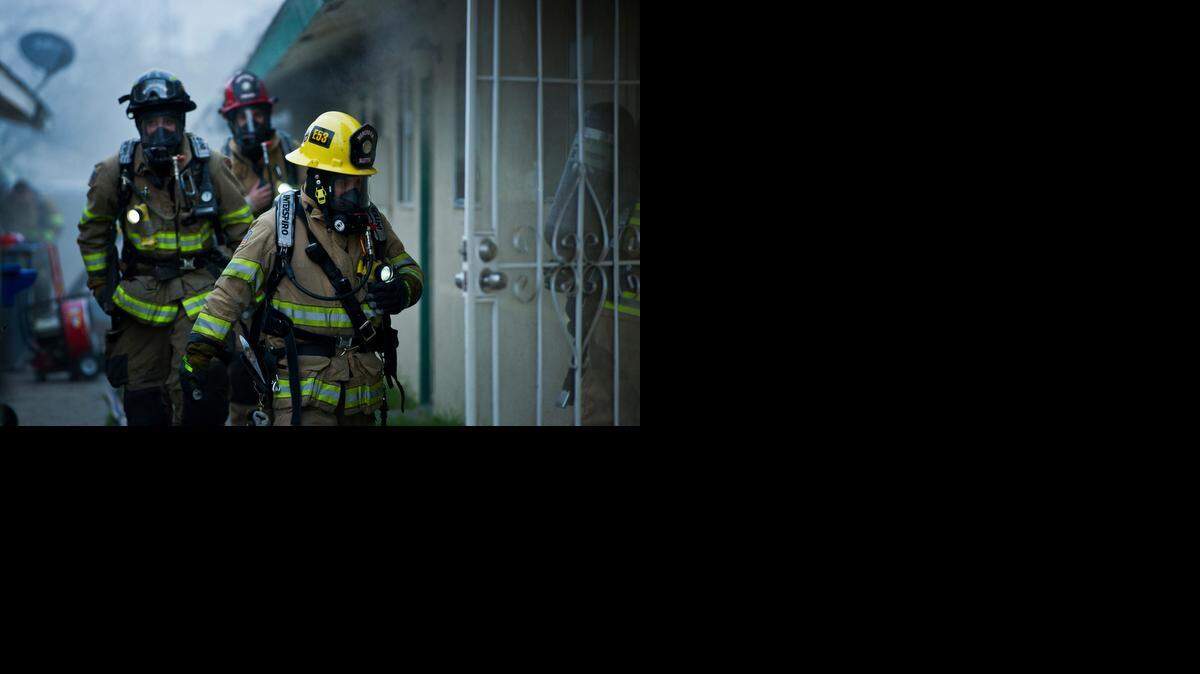 
City of Merced firefighters respond to the scene of a house fire at 329 W. 11th St. on Wednesday. According to Merced fire Battalion Chief Shawn Henry, one man was treated for smoke inhalation and the cause of the fire is unknown.
