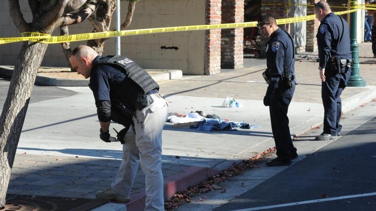 Los Banos police officers for a shell casing in the 600 block of I Street on Friday, Nov. 27, 2015.