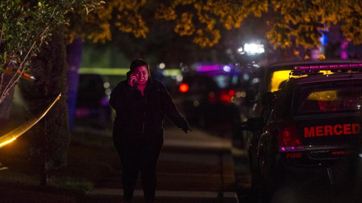 A woman becomes emotional while speaking on her phone as Merced police investigate a homicide in the 3300 block of San Mateo Court in Merced on April 28 .