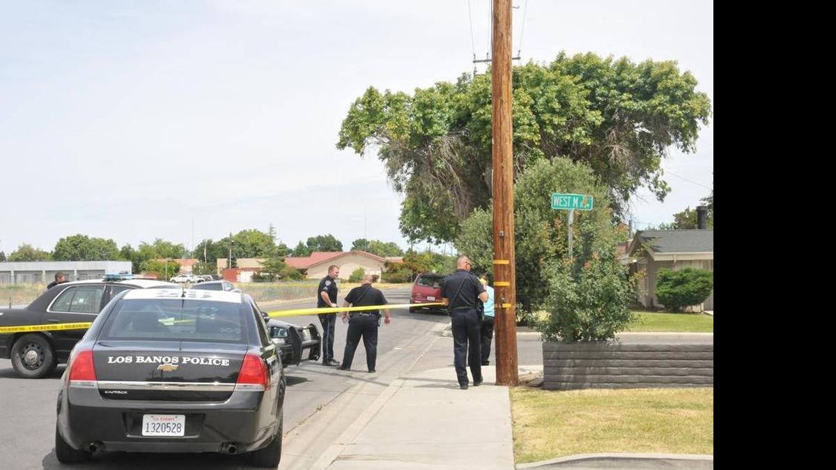 
Los Banos police officers mark off areas where a Mendota man was shot Thursday.
