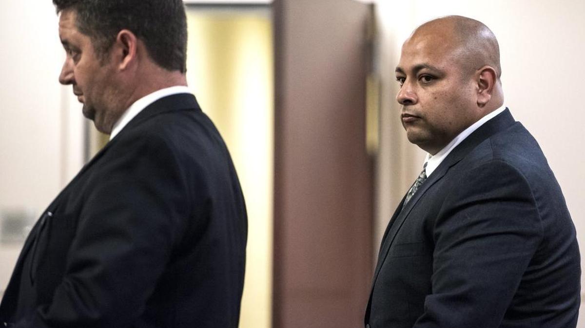 CHP Officer Gilbert Gutierrez looks to his attorney Brian Andritch, left, as he stands before Judge Ronald Hansen in Merced Superior Court on Friday, March 4, 2016. Gutierrez is accused of molesting a 10-year-old girl twice, and faces two counts of lewd and lascivious acts upon a child. Gutierrez is expected back in court April 18 to file a motion to dismiss the case.