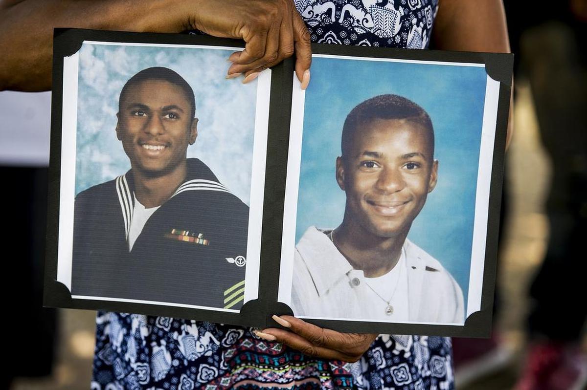Merced resident Marylene Riley, holds photos of her two sons Michael, left and Marlis, right at the cemetery where her two sons are buried in Merced, Calif., on Friday, July 20, 2018. The Merced Police Department announced on Thursday, that an arrest has been made for the 2008 murder of Michael Riley. Riley, a United States Navy veteran who served in Iraq and Afghanistan, was shot and killed on Oct. 7, 2008 near the Village Meadows Apartments in the 1100 block of Loughborough Drive. Nearly a year later, Marlis Riley was killed following a fight with two men on Sept. 12, 2009. 
