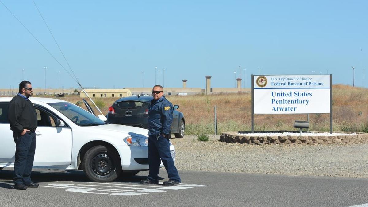 U.S. Bureau of Prisons officials stand guard Saturday, May 13, 2017, in front of the U.S. Penitentiary Atwater.