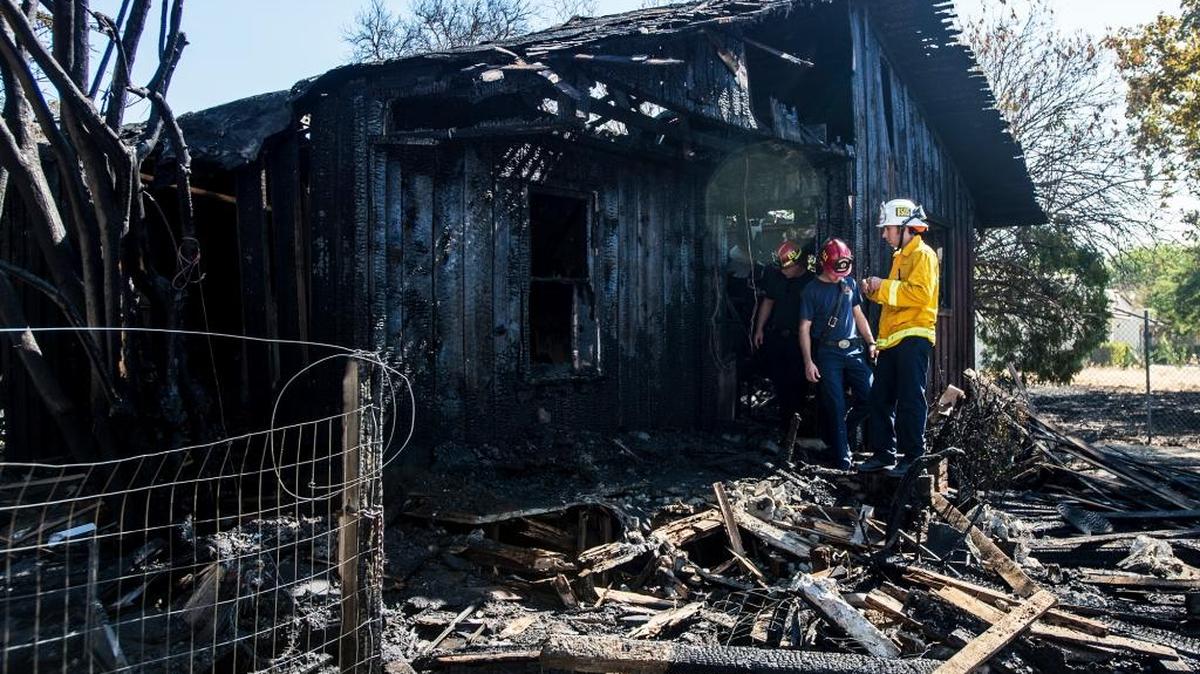 
Merced firefighters on Monday investigate a vacant structure that burned the night before. 
