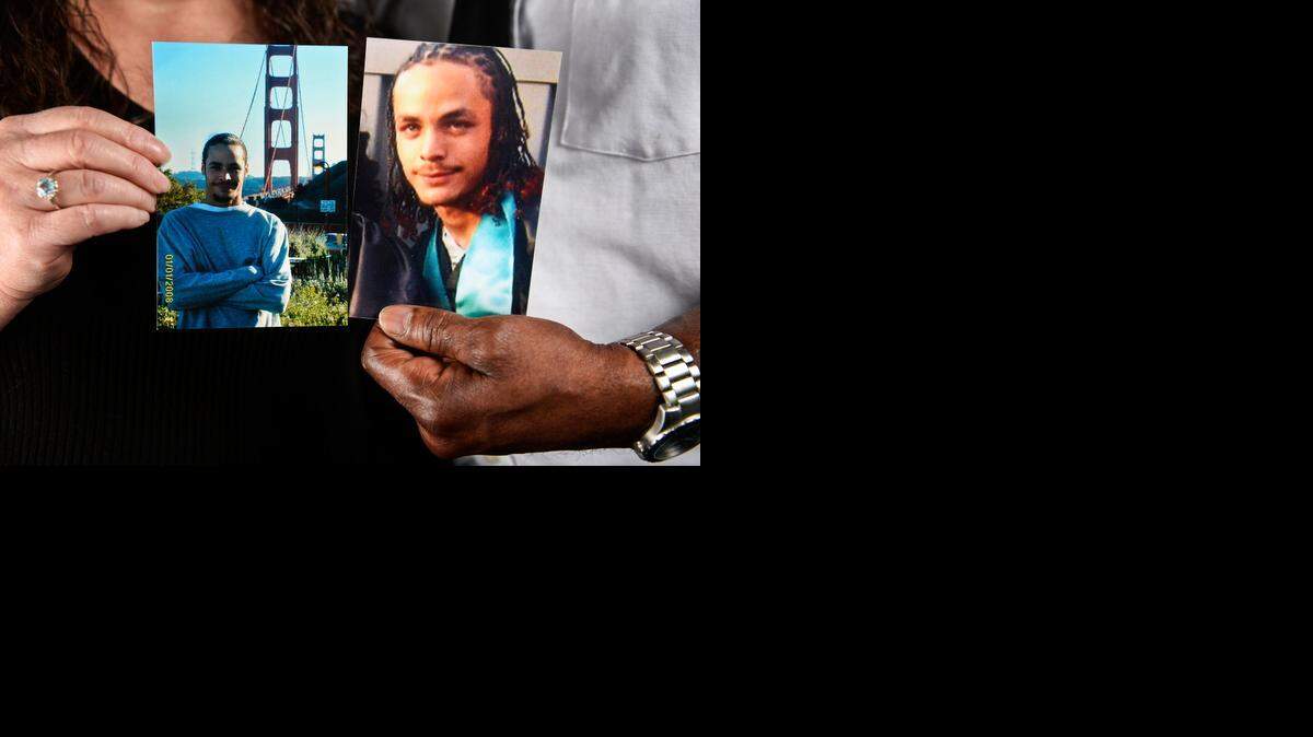 
Diane Reis and Robert Fisher hold photos of their son Marcus Fisher, who was gunned down during a New Year's Eve party on Jan. 1, 2014. No arrests have been made.
