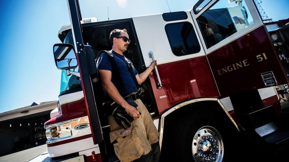 
Merced Fire Department engineer Nate Frankhauser climbs down from the engine at Station 51 in Merced. The department received permission Tuesday to hire a temporary employee, who will assess potential staffing needs as the city grows. 
