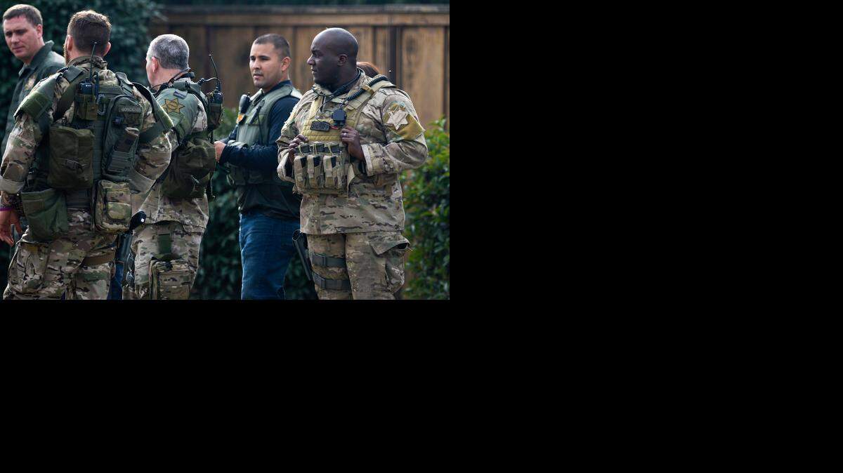 
Merced County Sheriff’s Department SWAT members gather after a standoff that lasted nearly three hours in the 5900 block of Salisbury Court in the McSwain area of Merced County, on Friday. John S. Grissom, 42, barricaded himself inside the home Friday morning as sheriff's deputies attempted to arrest him on a felony warrant in connection with an incident earlier in the week. Grissom surrendered to sheriff's deputies shortly after 1 p.m.
