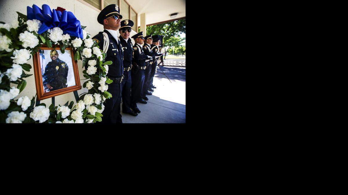 
A photograph of Merced police Officer Stephan Gray is displayed during a memorial for Gray at the Merced Police Department on Wednesday. Gray, 34, was shot and killed in the line of duty April 15, 2004, while chasing a gang member.


