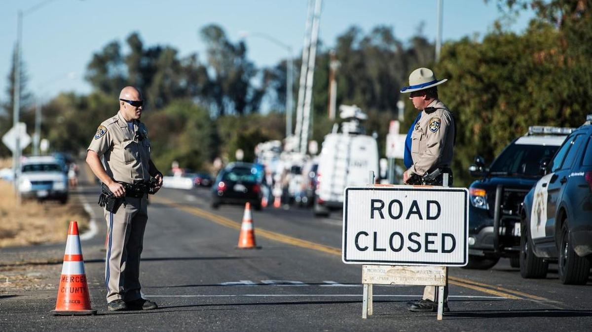California Highway Patrol officers close Lake Road at the intersection of East Bellevue Raod near the University of California, Merced, after a man stabbed and wounded four people on the campus before being shot and killed by police on Wednesday, Nov. 4, 2015.