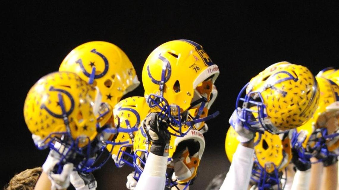 Three Dos Palos High School varsity football players were arrested Wednesday in connection with a “hazing investigation.” Investigators would not say whether the allegations involved any sexual criminal activity and said they had not ruled out the possibility of making additional arrests. Dos Palos varsity football team members hold up their helmets during the playing of the National Anthem Friday night, Nov. 27, 2015. Enterprise file photo