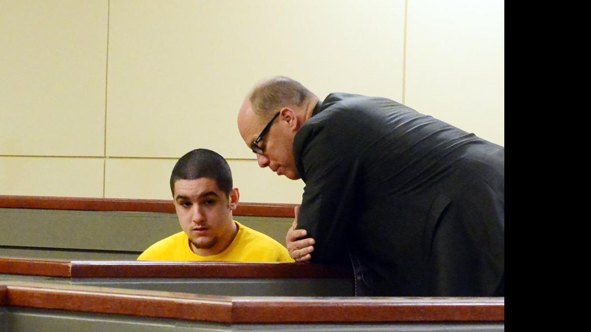 
Defense attorney Adam Stewart speaks with Jacob Tellez, 18, while they wait inside a Merced County courtroom for a preliminary trial to begin in November. Tellez and co-defendant Ethan Morse later were found innocent of killing 18-year-old Bernabed Hernandez-Canela, who was shot near an orchard outside a large house party near Atwater.

