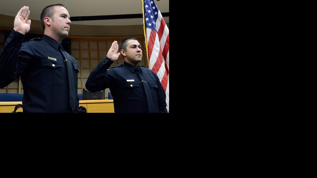 
David Miller, 29, left, and Jose Garcia, 31, are sworn in Friday inside the Merced City Council chamber. The new additions bring the city’s total number of officers to 84, according to Chief Norm Andrade.
