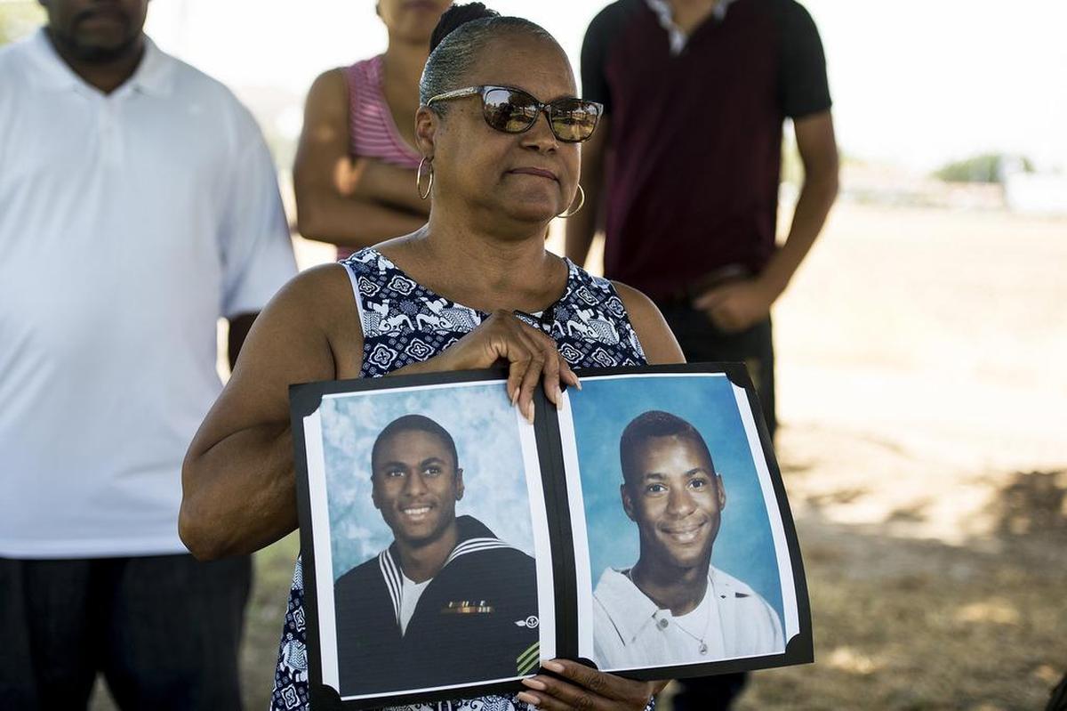 Merced resident Marylene Riley, holds photos of her two sons Michael, left, and Marlis, right, at the cemetery where her two sons are buried in Merced, Calif., on Friday, July 20, 2018. The Merced Police Department announced on Thursday, that an arrest has been made for the 2008 murder of Michael Riley. Riley, a United States Navy veteran who served in Iraq and Afghanistan, was shot and killed on Oct. 7, 2008 near the Village Meadows Apartments in the 1100 block of Loughborough Drive. Nearly a year later, Marlis Riley was killed following a fight with two men on Sept. 12, 2009. 