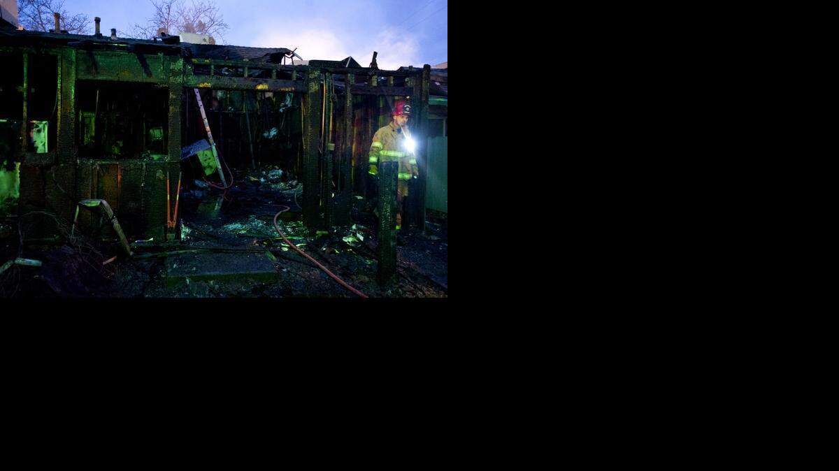 
Merced City Fire and Cal Fire Merced County crews work to secure the scene of an early morning structure fire in the 300 block of T Street in Merced, Calif., Wednesday, Jan. 21, 2015. According to Merced City Fire Department Battalion Chief Billy Alcorn, the fire, which has been ruled suspicious, started in a vacant unit of an 11 unit Merced Golden Manor apartment complex near the intersection of T Street and West 3rd Street. No injuries were reported and the American Red Cross was present on scene to assist with shelter and care of displaced residents.

