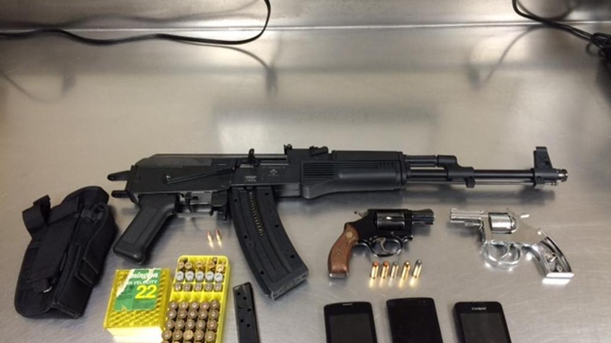 A man and a woman from Merced were arrested Saturday when investigators seized a stolen “AK-47-style rifle” and other weapons inside their home, the Police Department reported.