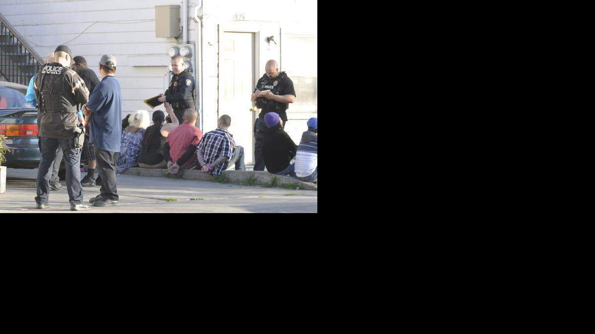 
Merced police officers question residents Wednesday afternoon during a narcotics investigation. 
