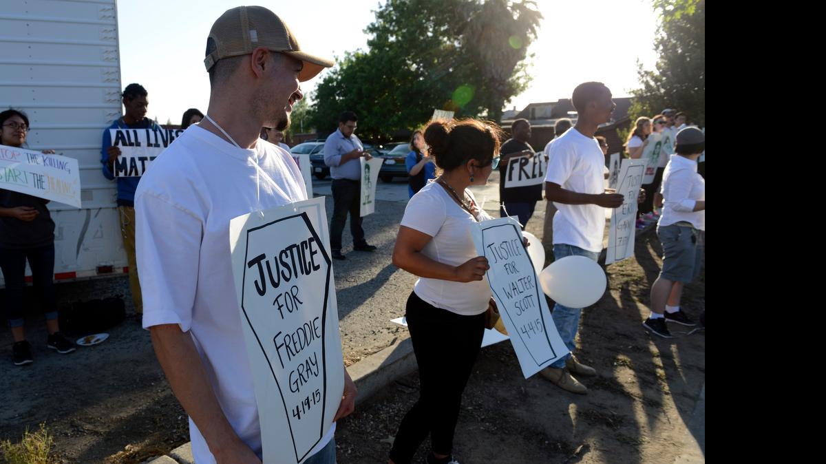 
About 30 demonstrators gather on M and 16th streets in Merced on Friday to stand in solidarity with Baltimore residents who have demonstrated for Freddie Gray, the 25-year-old black man who died after suffering a spinal cord injury in police custody. The day was also May Day, also called International Workers Day.
