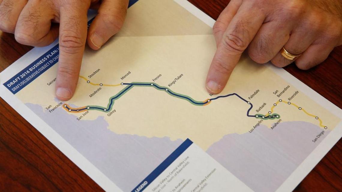 Dan Richard, chairman of the board that oversees the California High-Speed Rail Authority, gestures to a map showing the proposed initial construction of the bullet train in the revised business plan, Thursday in Sacramento, Calif. Officials of the high-speed rail system say they will push to build the first 250 miles of the system north from the Central Valley to Silicon Valley using already-approved funding for the project.