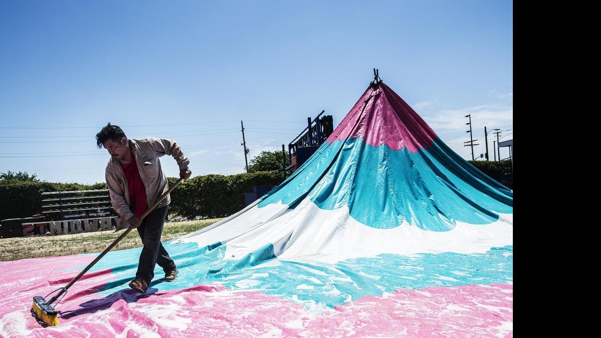 
Andres Andrade of Mexico washes the exterior of a tent at the Merced County Fairgrounds on Friday. The Merced County Fair begins Wednesday and runs through June 14.
