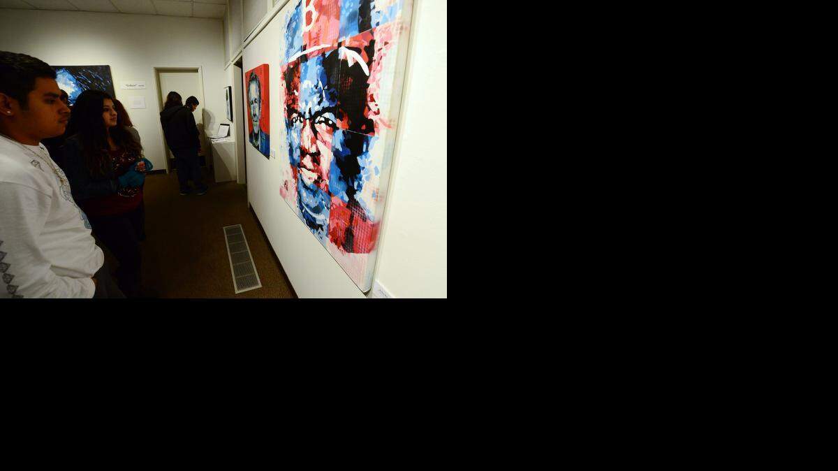 
Merced College students look at the painting “Jackie Robinson” by Jay Hill, 53, of Fremont at the opening reception of his show “Endure” at the Merced College Gallery on Wednesday. The exhibit featuring his street art-inspired paintings will be up through Feb. 4.

