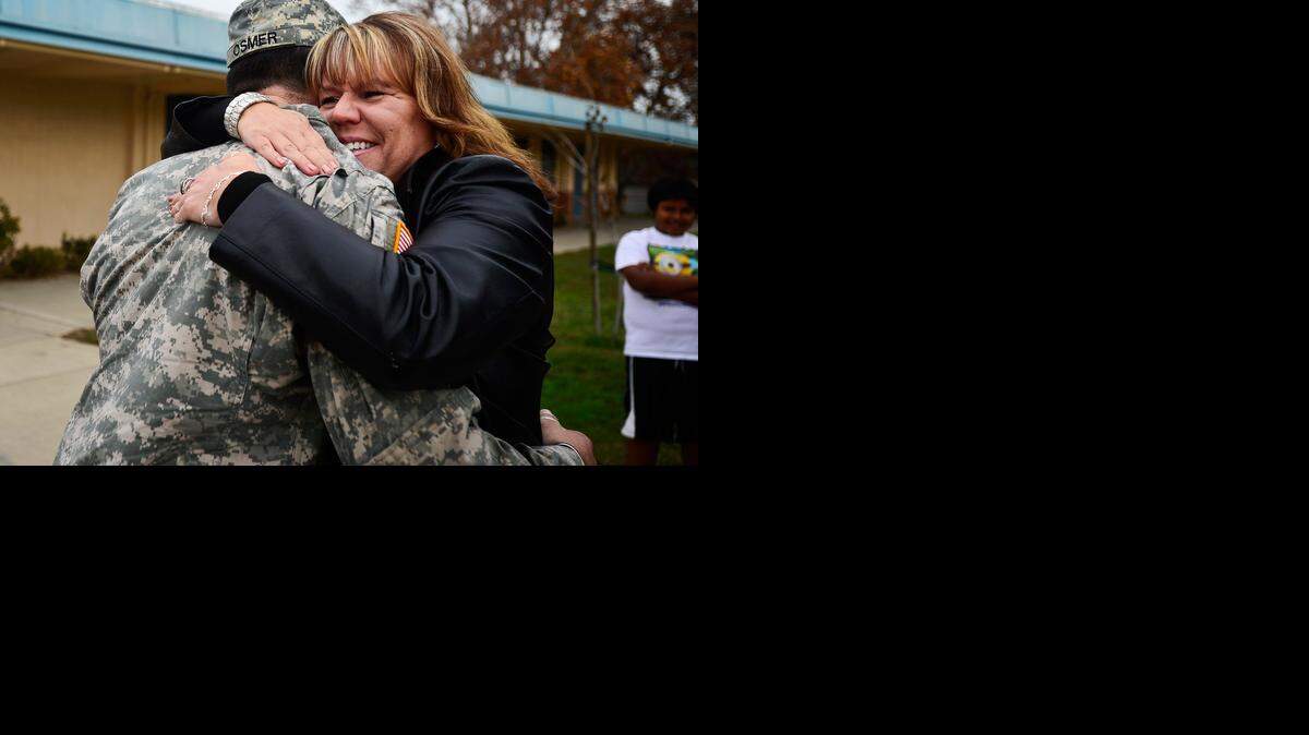 
Bellevue Elementary School teacher Tracy Hunter greets U.S. Army 101st Airborne specialist Aaron Osmer, 20, of Atwater at Bellevue Elementary School in Atwater on Dec. 5. Hunter and her 2013-14 sixth-grade class wrote Osmer and his platoon while they were stationed in Afghanistan.
