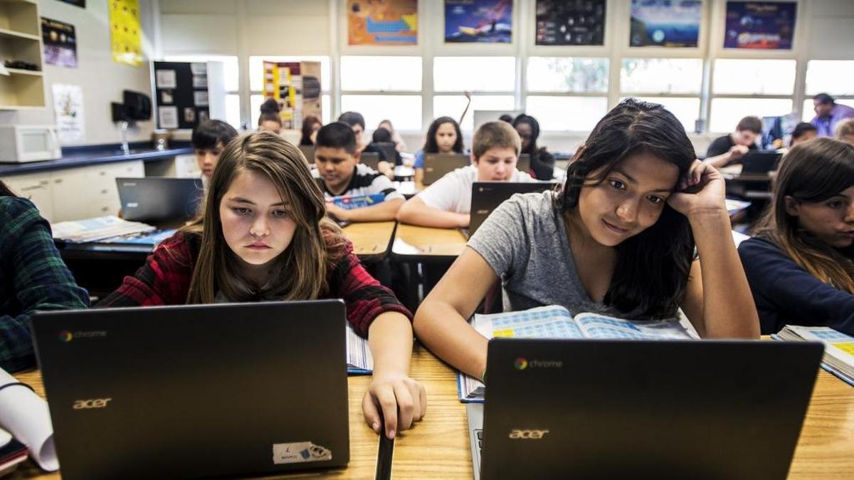 
Hoover Middle School eighth-graders Kimberly Perez, 14, left, and Angelica Garcia, 13, work on Chromebooks during Ruben Rodriguez’s physical science class at Hoover Middle School in Merced on Friday.
