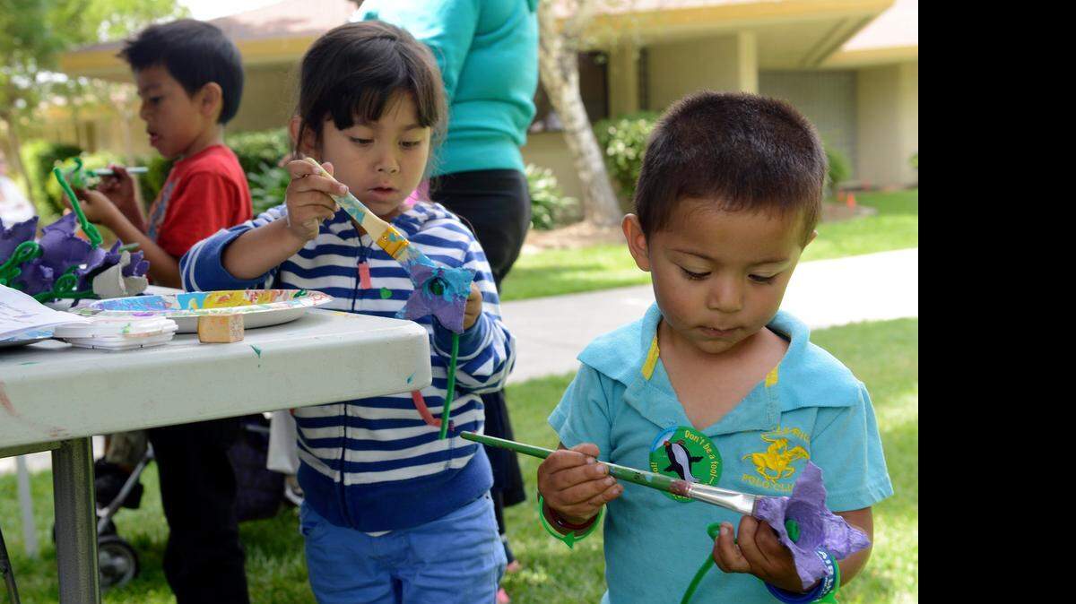 
Alexa Cruz, 5, and Eliszanthony Gomez, 2, both of Merced, paint flowers made of recycled material during an Earth Day event at Golden Valley Health Centers in Merced on Friday. Several booths at the center tried to make conservation fun for area children.
