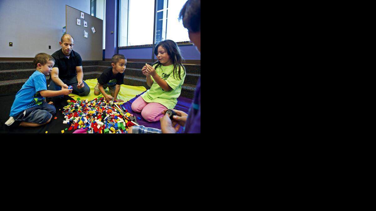 
From left, Mason Hurtado, 3, Jose Hurtado, 28, Robert Paul, 6, Mya Paul, 7, and Zack Paul, 9, all of Merced, play with Legos during Lego Hour at the Merced County Library at 2100 O St. on Friday. The program was made possible by the donation of an extensive Lego collection by Modesto High School senior Shilin Patel.
