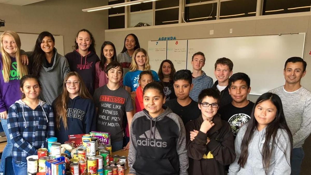 Students at Hoover Middle School show some of the food they’ve collected for the Merced County Rescue Mission.