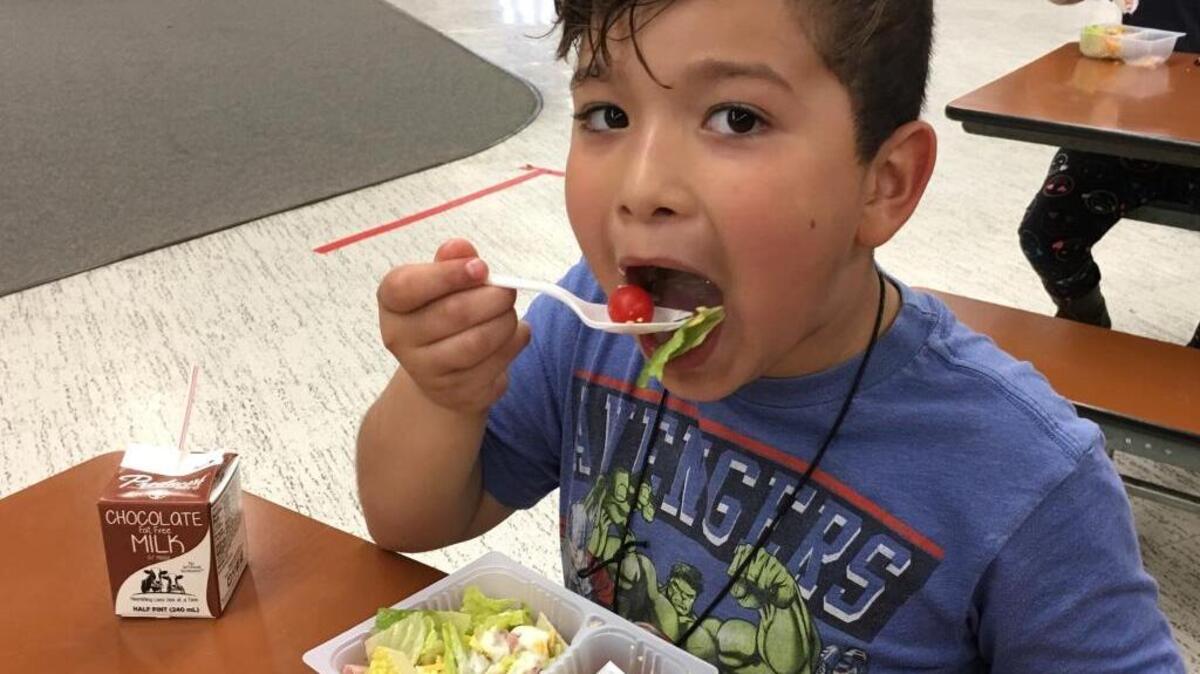A student enjoys a “Super Snack” during an after school program at Gracey Elementary in Merced.