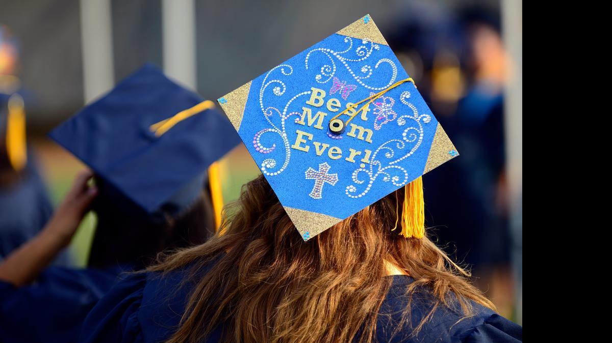 
Cindy Roberts, 46, of Merced wears a mortarboard decorated by her 10-year-old daughter, Trinity, as she mingles with more than 1,000 graduates before they file into Merced College’s stadium for the 52nd commencement ceremony Friday in Merced. Family and friends cheered from the stands.
