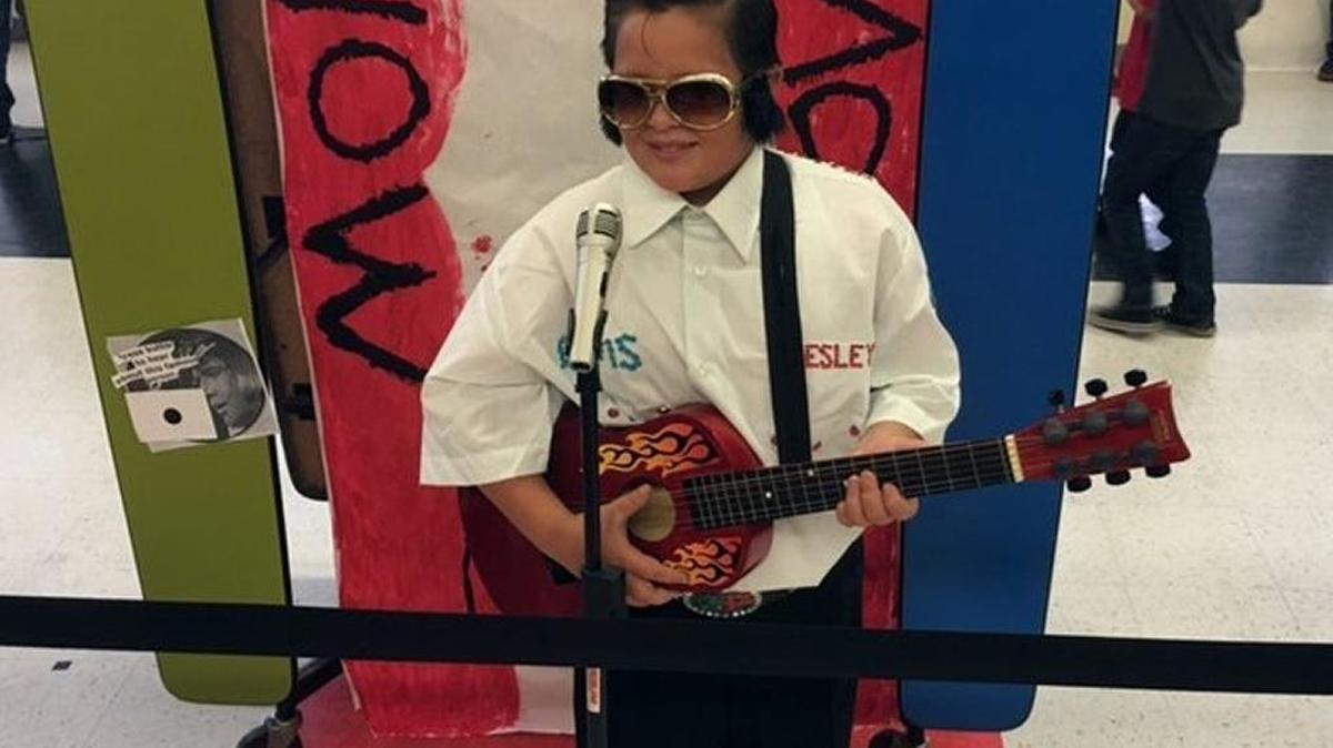 Sixth-grader Alexzander Bates portrays a side-burned Elvis Presley at Charles Wright Elementary in Merced on Thursday, May 5, 2016, as part of living wax museum history project.
