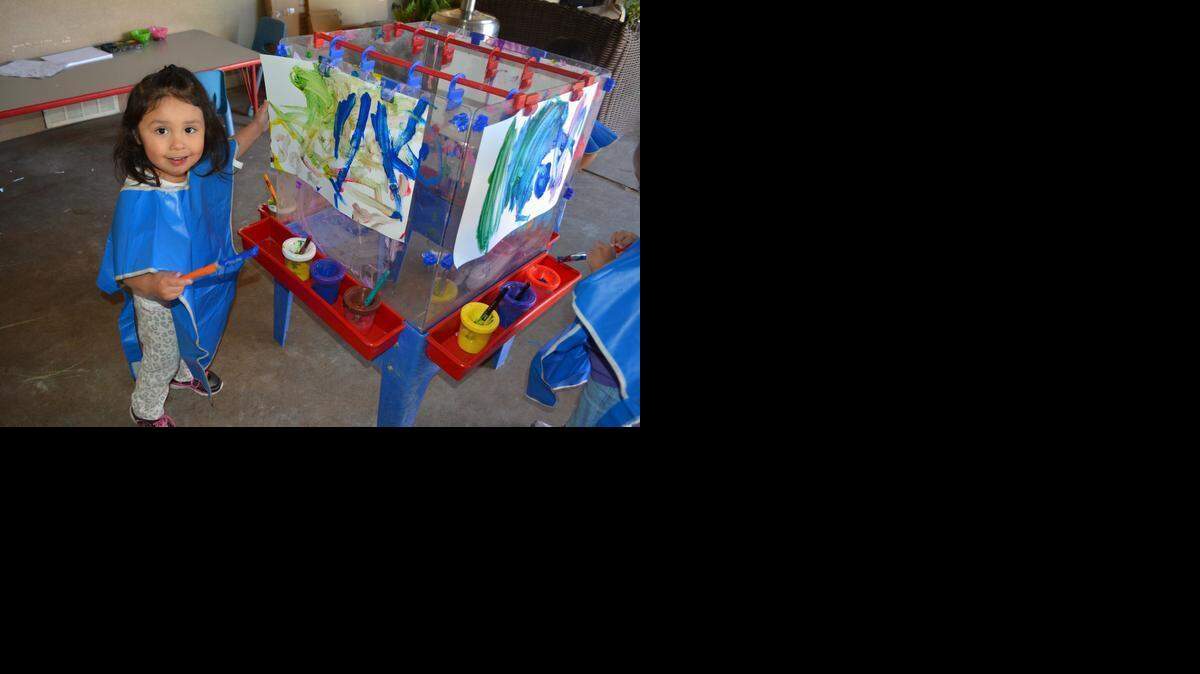 
Two-year-old Bella shows off her picture at the home daycare of Karen Elmore in Modesto, Calif., on March 3, 2015.
