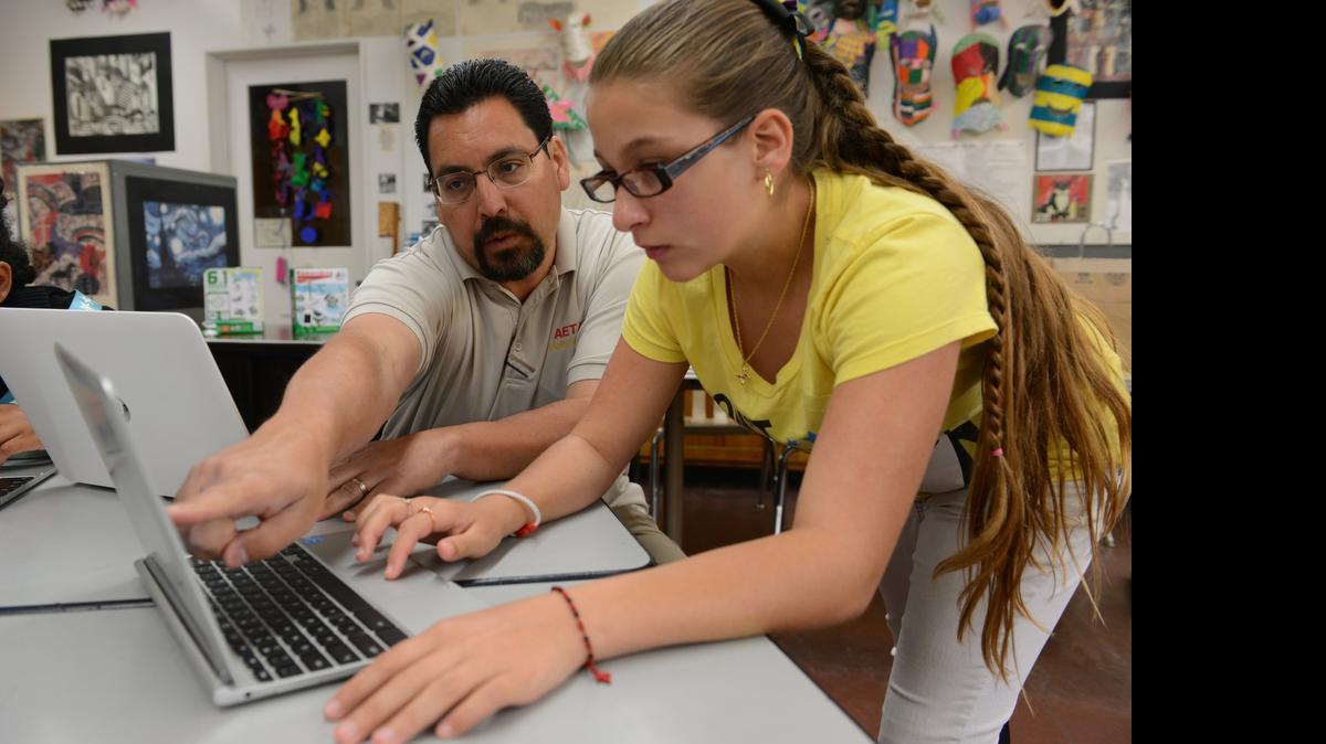 
STEM camp teacher Glenn Jones helps Dakota Jones work on her website about about solar energy during the STEM Science Camp at Mitchell Sr. Elementary in Atwater in 2014. The number of STEM jobs in the past decade has grown three times as fast as other fields, and experts believe that trend will continue into the next decade, California Superintendent of Public Instruction Tom Torlakson said.
