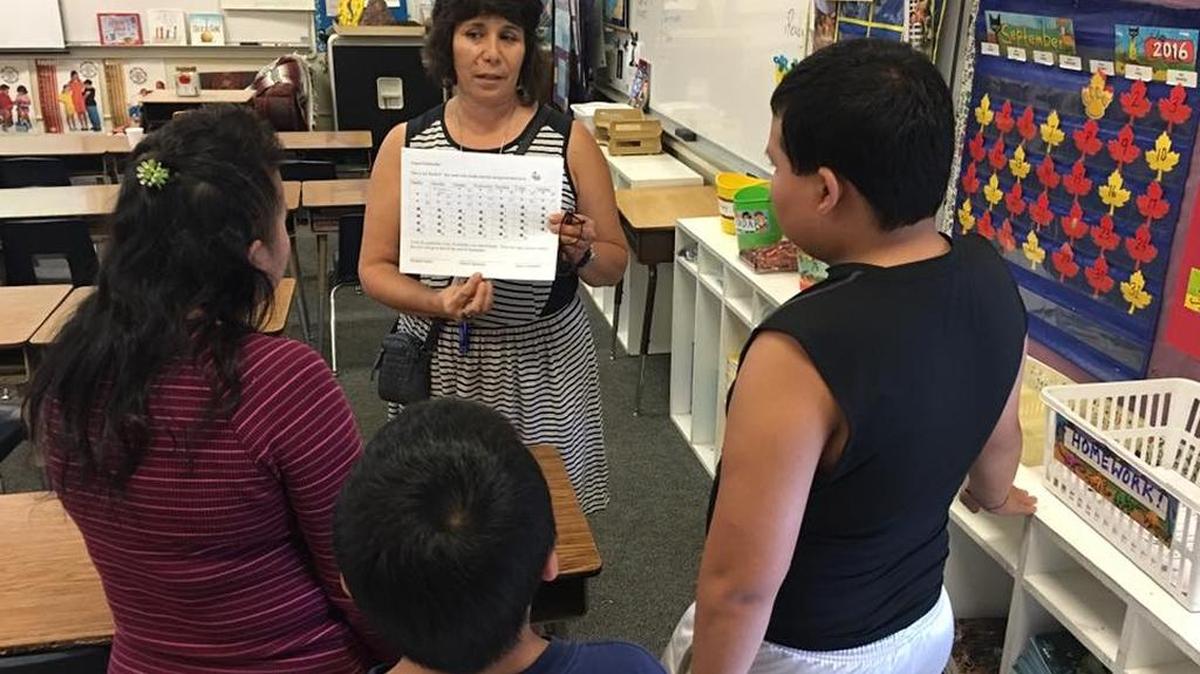 Sheehy Elementary teacher Joanne Garcia speaks with a family during Back to School night on Sept. 1.