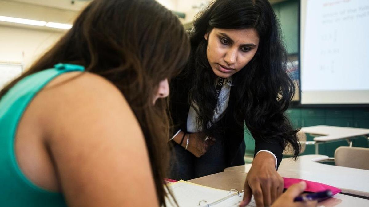 
Eighth-grade math teacher Navjot Dhillon helps a student solve a problem at Delhi Middle School in Delhi last month. California has released results from spring tests evaluating student performance against Common Core standards.
