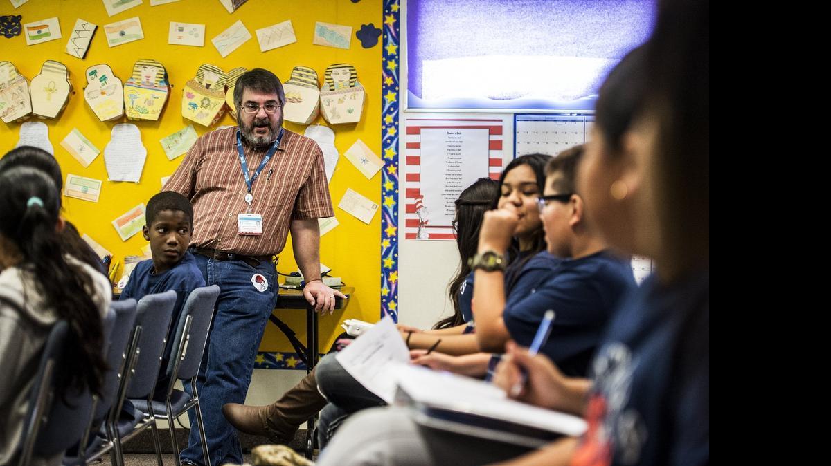 
Dr. Dan Ozeran, standing, an oncologist at Valley Children’s Hospital in Madera, educates Cesar E. Chavez Middle School students on careers in the health care field in Planada on Friday. The Medical Academy for Students Mastering Technology, Education, Research and Science, better known as the M.A.S.T.E.R.S. program, prepares students interested in joining the medical academy at Le Grand High School.
