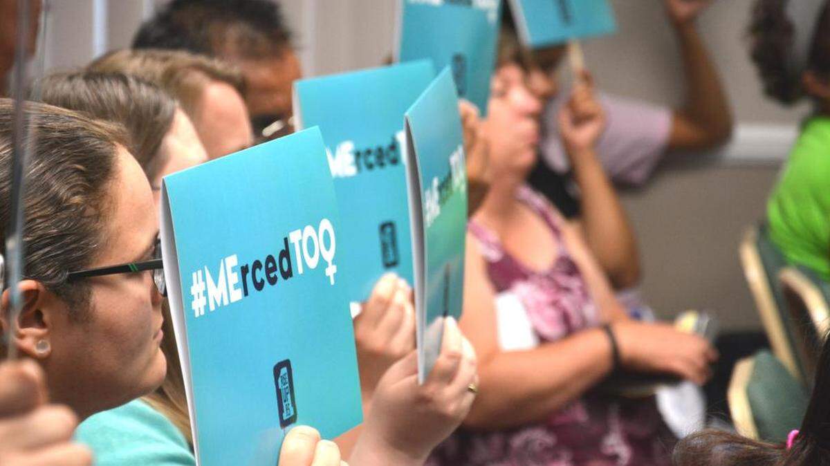 Teachers, students and supporters hold up #MErcedTOO signs, a play off the national #MeToo movement, during a Merced Union High School District board meeting Wednesday, June, 13, 2018, at the administrative building in Atwater.
