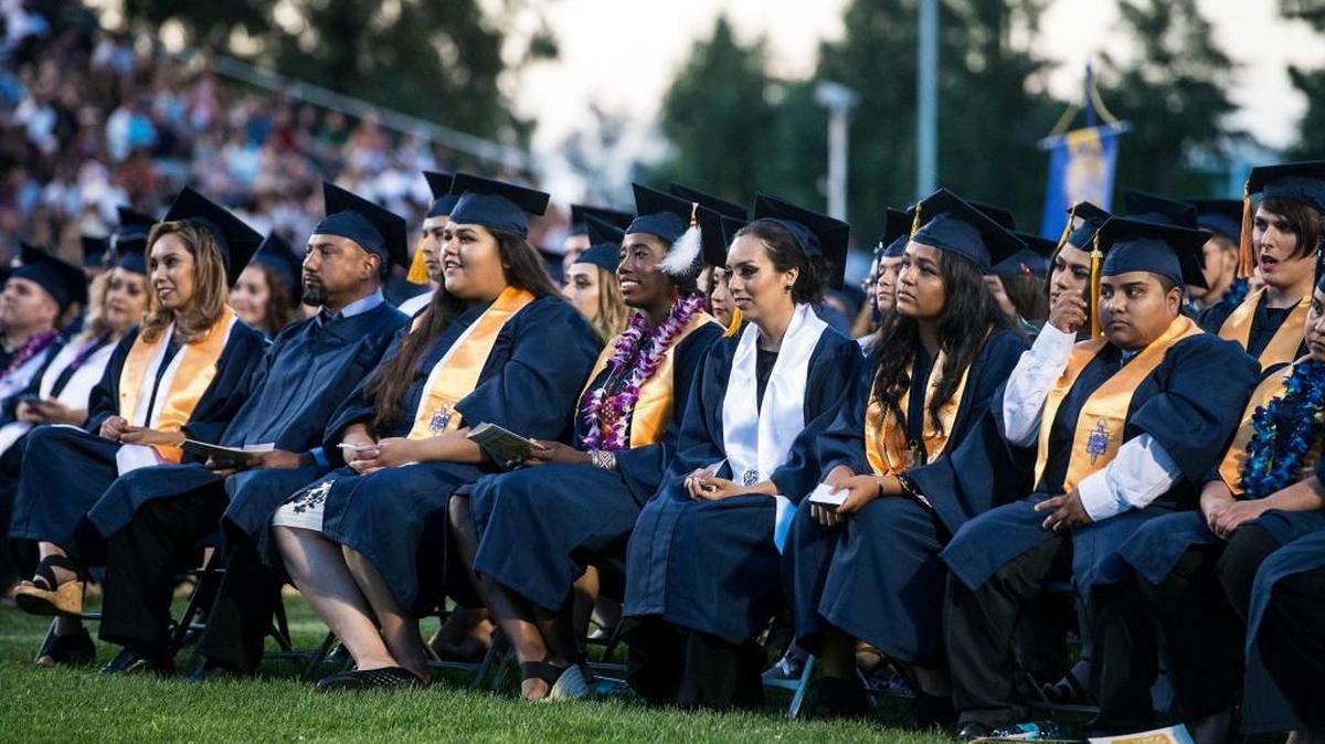 Merced College students attend their graduation ceremony at Stadium ’76/Don Odishoo Field in May.