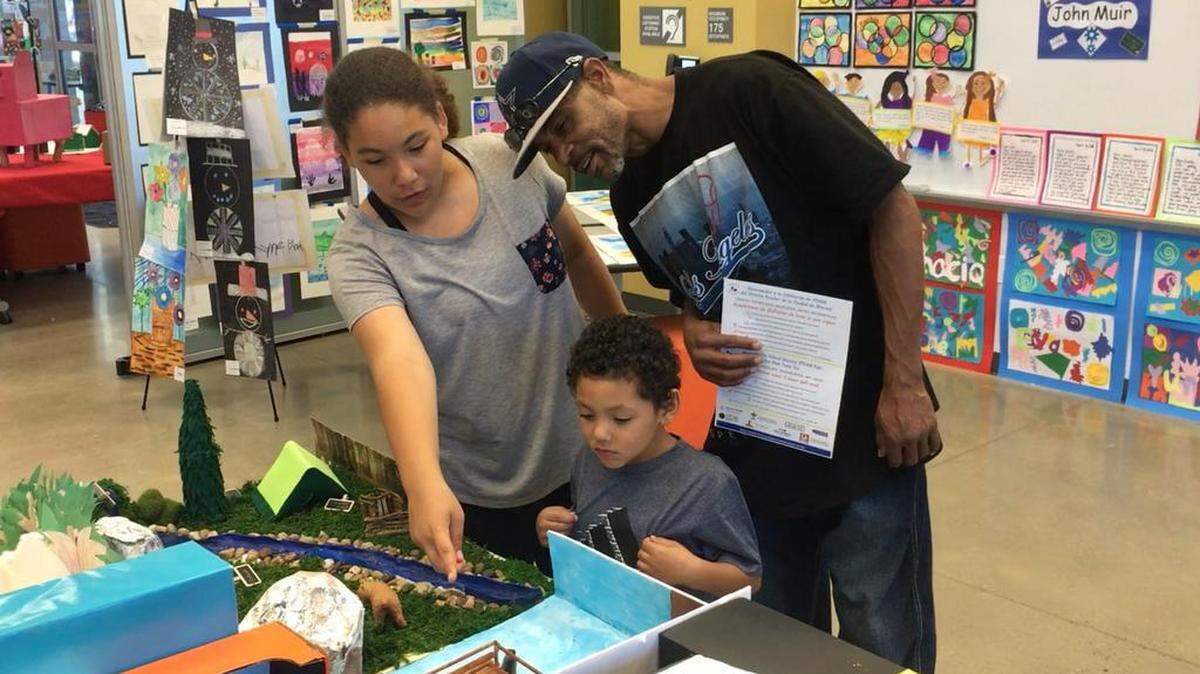 A family enjoys one of the student displays at the MCSD STEAM Fair on Thursday, May 17, 2018.