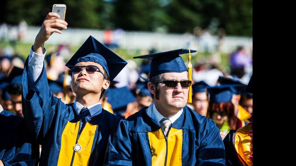 
Graduate Tao Ren, 29, of China takes a selfie during the UC Merced commencement ceremony for the School of Engineering and the School of Natural Sciences, in the university's South Bowl on May 16. More than 500 students received degrees.
