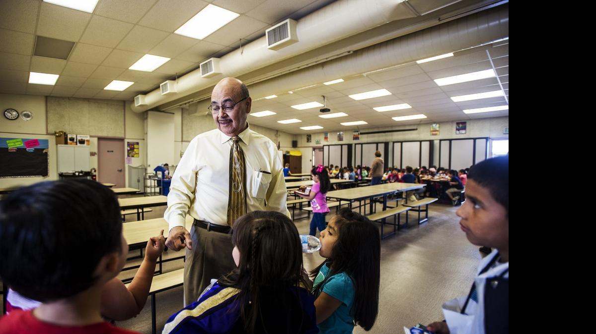 
Campus Park Elementary School Principal George Solis, 61, greets students during lunch in Livingston on Wednesday. Solis began working at the school as a custodian and bus driver in the late 1970s before becoming a teacher and eventually the school’s principal. He will be retiring at the end of the school year.
