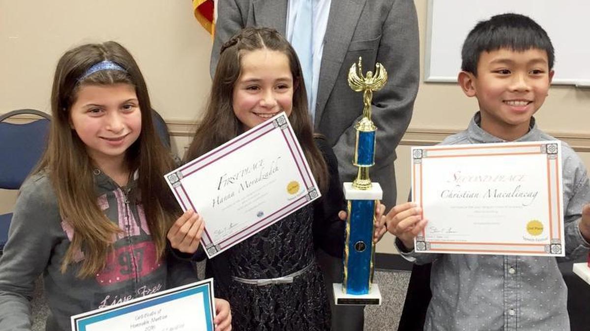 Merced County Office of Education Assistant Superintendent of Instructional Services John Magneson stands with several fifth grade winners from Our Lady of Mercy School in Merced at the Merced County Speech Festival awards on Jan. 27 at MCOE. From left, Riley Delworth, honorable mention, Hanna Moradzadeh, first place, and Christian Macalincag, second place, all attended the awards.