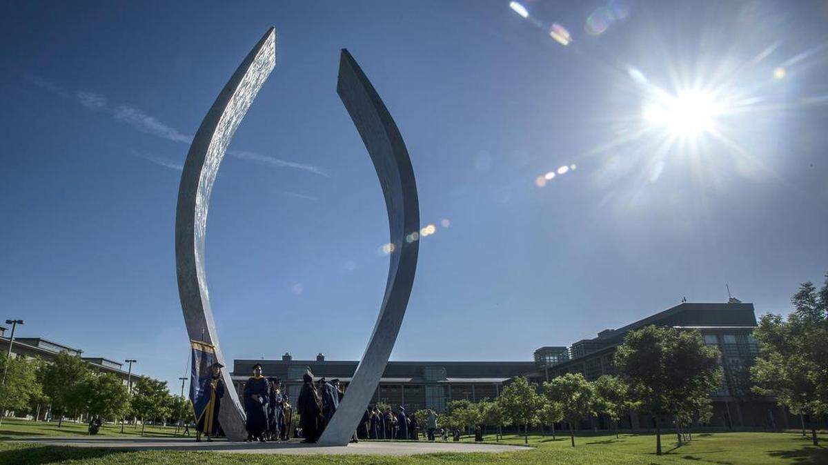 University of California, Merced graduates gather at the campus sculpture titled "Beginnings" prior to the commencement ceremony for the School of Engineering and the School of Natural Sciences, in the university's South Bowl, in Merced, Calif., Saturday, May 16, 2015. Over 500 students received degrees.